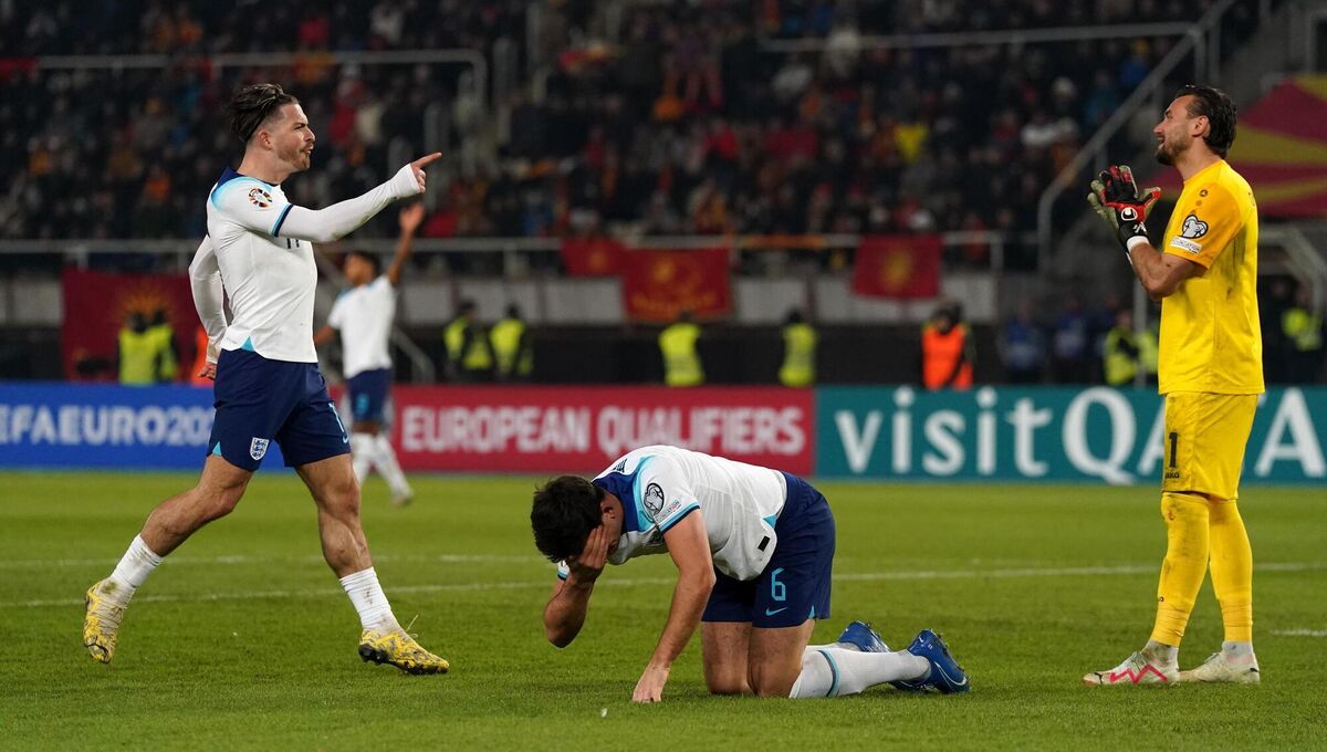 Jack Grealish runs in to speak to goalkeeper Stole Dimitrievski, as Harry Maguire lies injured.