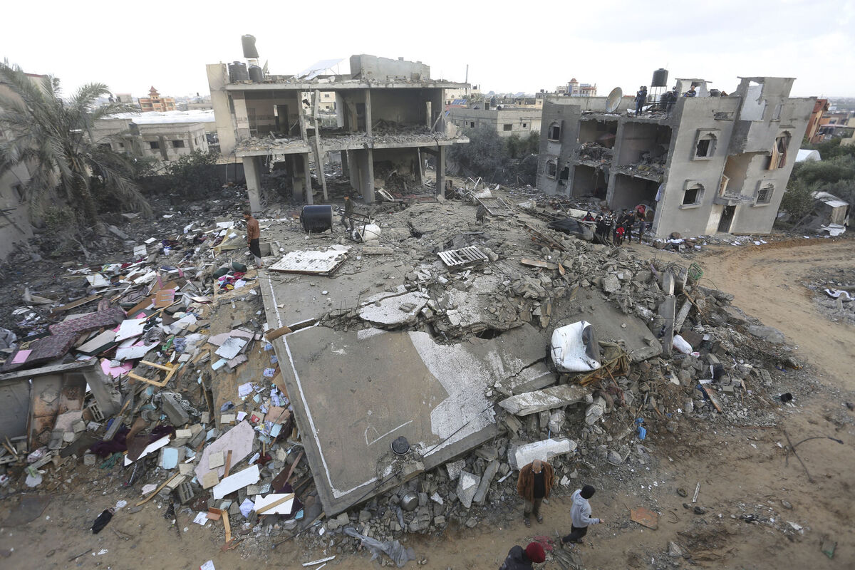 Palestinians look at houses destroyed in the Israeli bombardment of the Gaza Strip in Rafah on Monday. Picture: AP Photo/Hatem Ali)