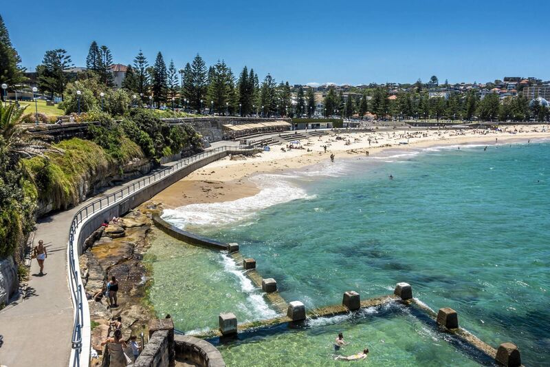 Swimmers and sunbathers enjoying the warm summer weather at the Ross Jones Rockpool and Coogee Beach.