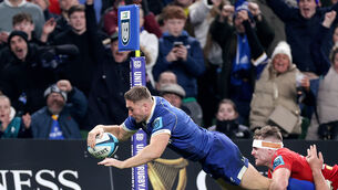 <p>GETTING THERE: Leinster's Jordan Larmour scores a try despite the efforts of Munster's Alex Kendellen  </p>