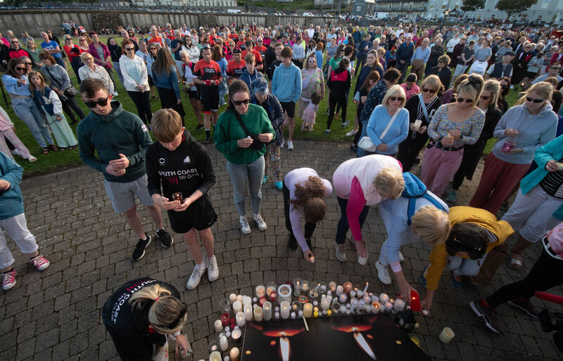Members of the public laying candles at the bandstand in Green Park in Youghal during a vigil for the two athletes who lost their lives in the Ironman last Sunday. Picture: Howard Crowdy Members of the public laying candles at the bandstand in Green Park in Youghal during a vigil for the two athletes who lost their lives in the Ironman last Sunday. Picture: Howard Crowdy