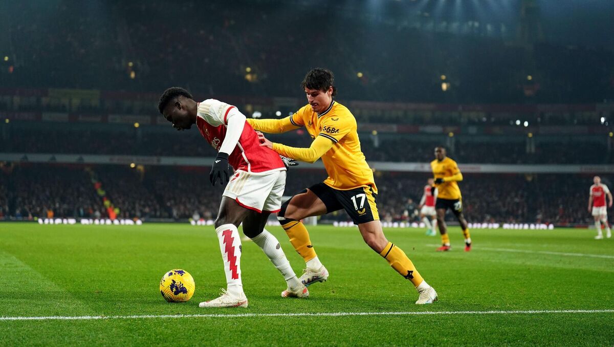 Arsenal's Bukayo Saka and Wolverhampton Wanderers' Hugo Bueno battle for the ball.