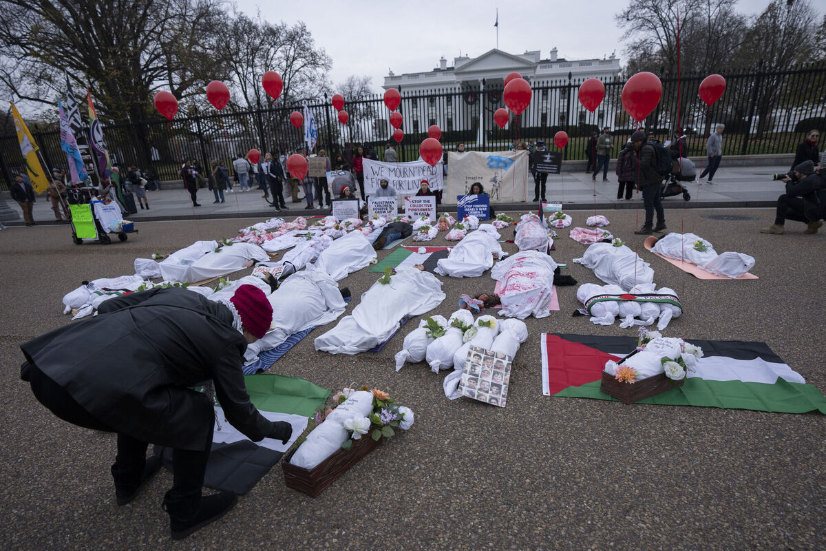 Palestinian supporters calling for an immediate ceasefire, stage a mock funeral with dolls and people wrapped in white cloth smeared with red pain to resemble Palestinian victims of the Israel-Hamas war, in front of the White House in Washington, Saturday, Dec. 2, 2023. (AP Photo/Manuel Balce Ceneta) Palestinian supporters calling for an immediate ceasefire, stage a mock funeral with dolls and people wrapped in white cloth smeared with red pain to resemble Palestinian victims of the Israel-Hamas war, in front of the White House in Washington, Saturday, Dec. 2, 2023. (AP Photo/Manuel Balce Ceneta)