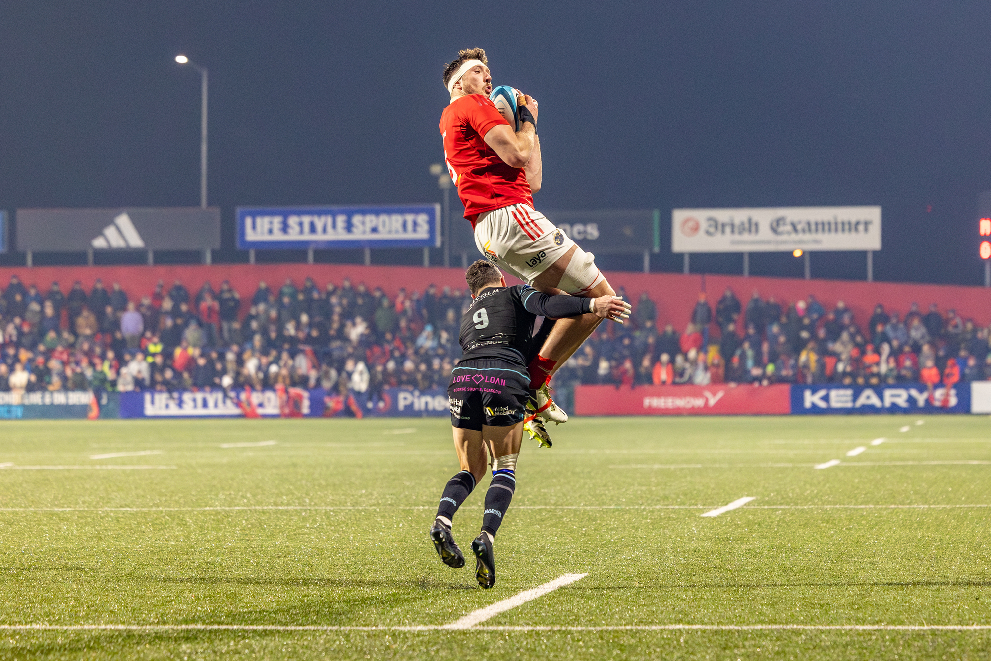 FLYING HIGH: Munster's Tom Ahern taken in the air by Glasgow Scrumhalf Sean Kennedy. Pic: Kieran Ryan-Benson
