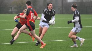 <p>ROCHESTOWN'S James Burke dishes off possession in Wednesday's Corn Ui Mhuiri preliminary quarter-final against Coachford College at Bishopstown GAA. </p>