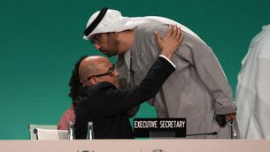 <p>UN climate chief Simon Stiell embraces Cop28 president sultan Ahmed al-Jaber as he returns to a plenary session at the climate summit on Wednesday. While it is true that even the mention of reducing fossil fuels was a first for a Cop agreement, it is hardly groundbreaking. Picture: Kamran Jebreili/AP.</p>