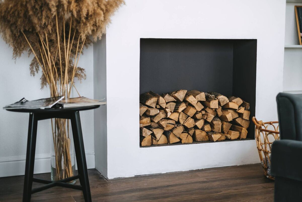 Fill your empty fireplace with cut logs, raw or painted up. Offcuts can also be placed on a backing board to seal the fireplace off when not in use. File picture