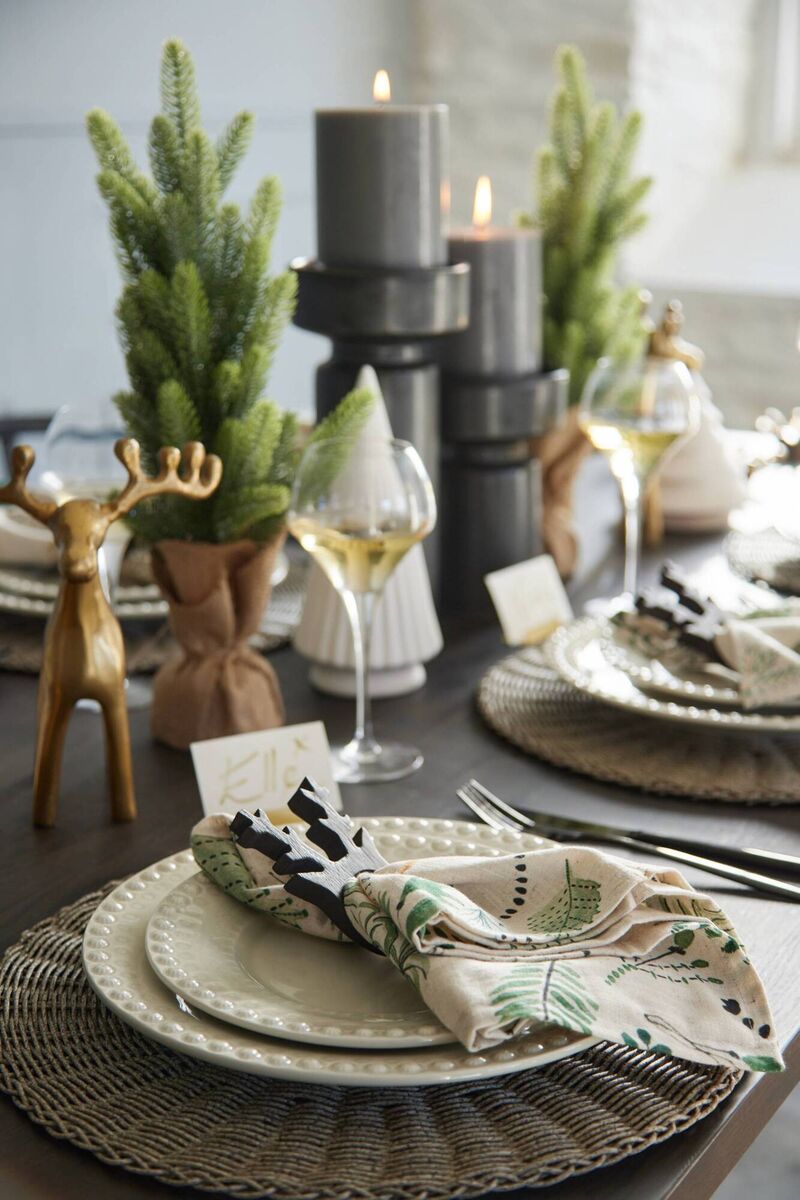 Meadows and Byrne tablescape: Leaf-print napkin set, €29, Fantasy dinner plate, €19, salad plate, €15, rattan placemat, €5.95, napkin rings set of four, €17.95, Donner gold reindeer, €22, Holden candle holder, black, small, €25, Holden candle holder, black, large, €29, Chef &amp; Sommelier Krysta white wine glass, set of six, €55. 