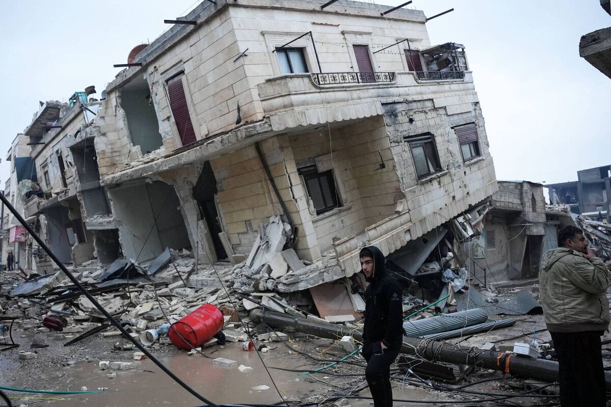 Residents stand in front of a collapsed building following an earthquake in the town of Jandaris, in the countryside of Syria's northwestern city of Afrin on February 6. Picture: Getty Residents stand in front of a collapsed building following an earthquake in the town of Jandaris, in the countryside of Syria's northwestern city of Afrin on February 6. Picture: Getty
