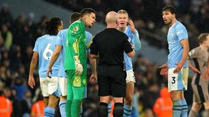 <p>Manchester City players surround referee Simon Hooper during the 94th-minute of their 3-3 draw with Tottenham.</p>