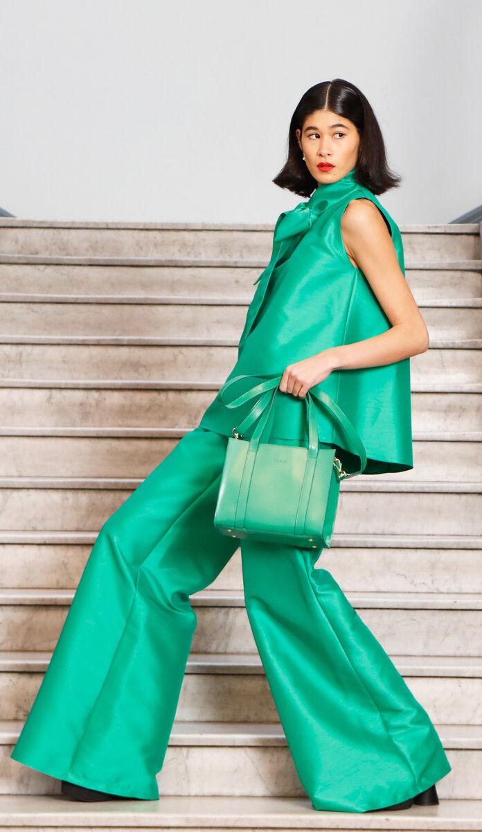 Model Ami wears green MYA top and CaAZ trousers by Roisin Linnane, earrings by The Silver Loom, and a green mini bag by Julie Peelo. Pic: Leon Farrell