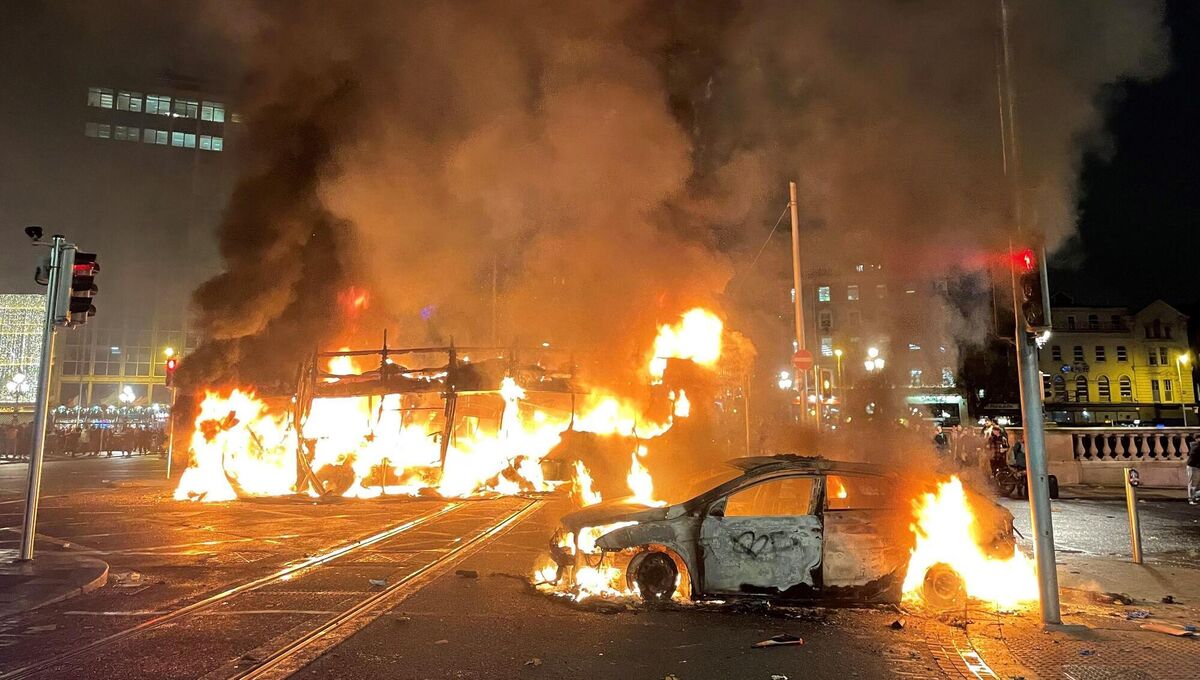 A bus and car on fire on O'Connell Street in Dublin city centre after violent scenes unfolded. A bus and car on fire on O'Connell Street in Dublin city centre after violent scenes unfolded.