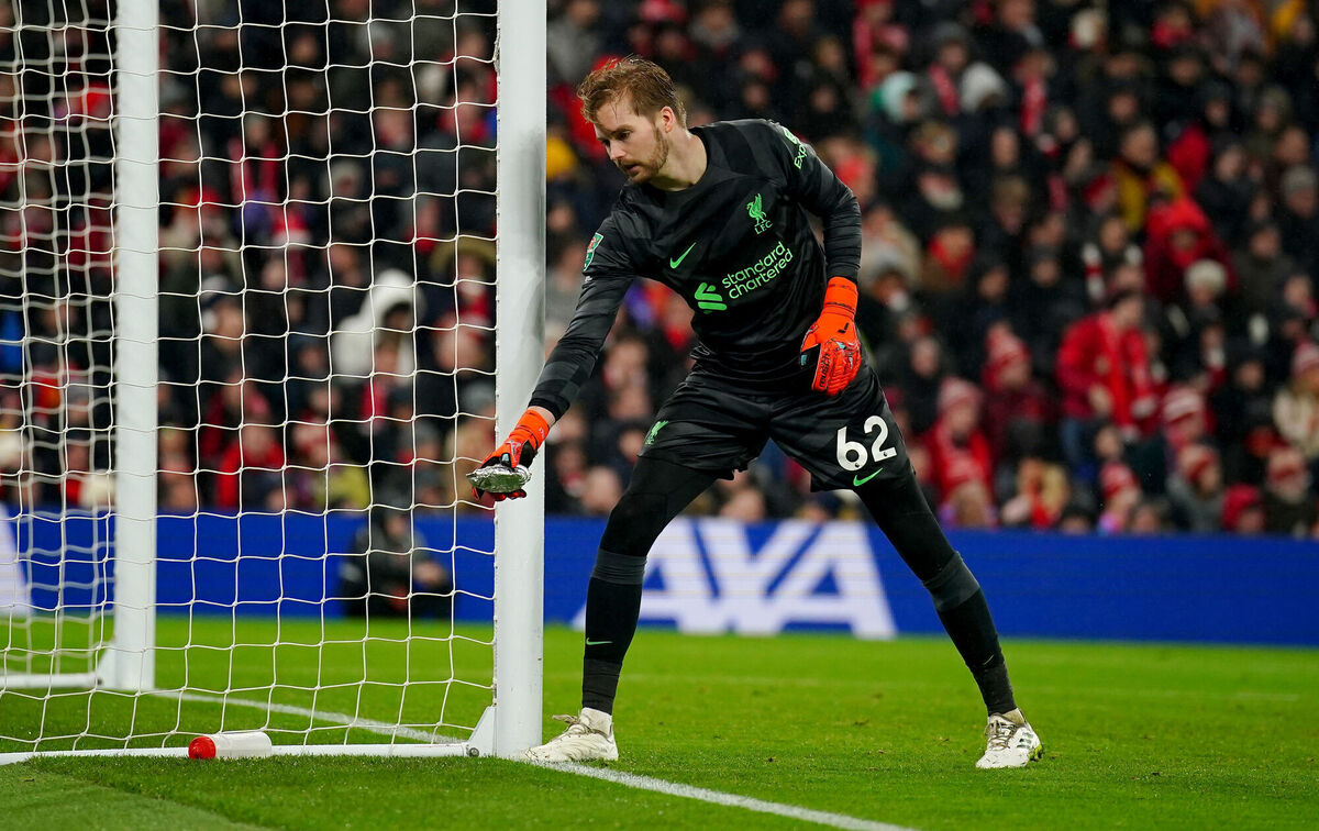 Liverpool goalkeeper Caoimhin Kelleher removes a pie that was thrown from the pitch. Photo credit: Peter Byrne/PA Wire.