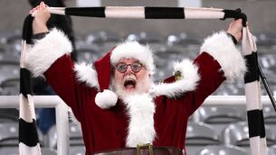 <p>A Newcastle supporter dressed as Santa Claus celebrates after the Premier League match between Newcastle United and Fulham last week. Picture: Stu Forster/Getty Images</p>