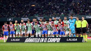 <p>Real Betis and Girona FC players and pose for the media with a banner reading 'Earn it on the pitch!' in protest against the Super League plans, before the La Liga match on Thursday. Pic: Fran Santiago/Getty Images</p>