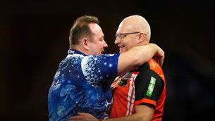 <p>Brendan Dolan reacts after his match against Mickey Mansell (right) on day eight of the Paddy Power World Darts Championship at Alexandra Palace. Pic: Zac Goodwin/PA Wire.</p>