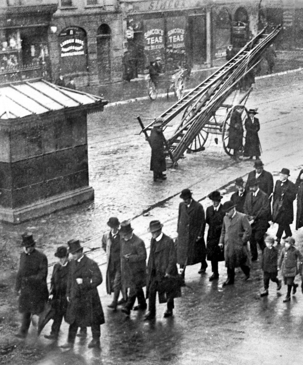 A religious procession passes the Fireman's Rest on St Patrick's Street, Cork, in 1915. 