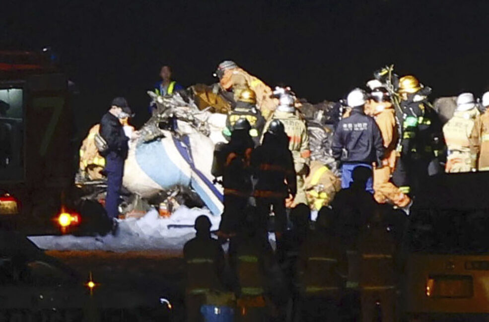Firefighters inspect a part of the wreckage of the burnt Japan Airlines plane on the runway of Haneda airport. Picture: Kyodo News via AP Firefighters inspect a part of the wreckage of the burnt Japan Airlines plane on the runway of Haneda airport. Picture: Kyodo News via AP