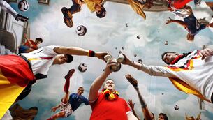 <p>PROST! German supporters celebrate at Cologne's main railway station, where ceilings have been decorated with paintings of football starts, in a Sistine chapel style. </p>
