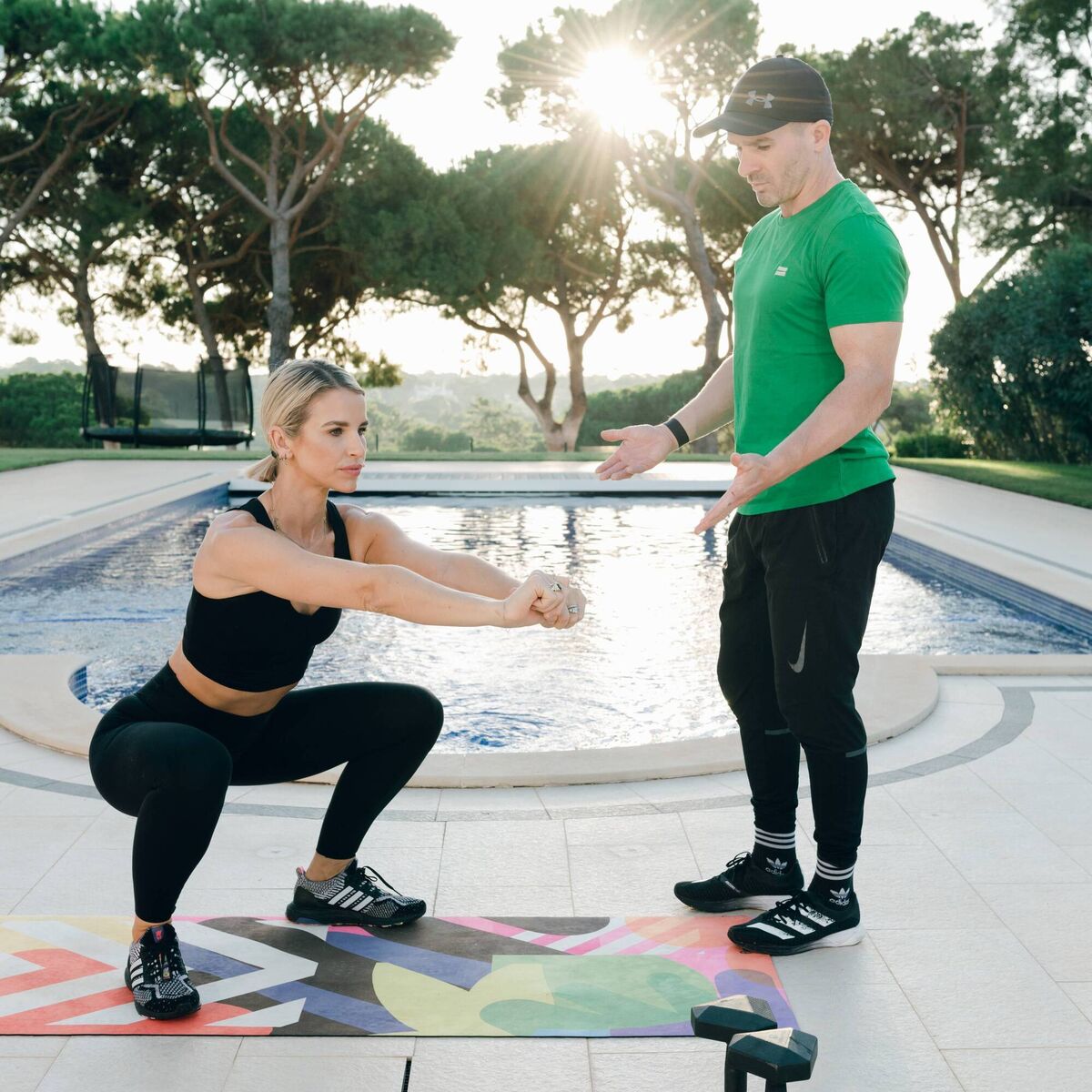 Coach John Belton and Vogue Williams in action.