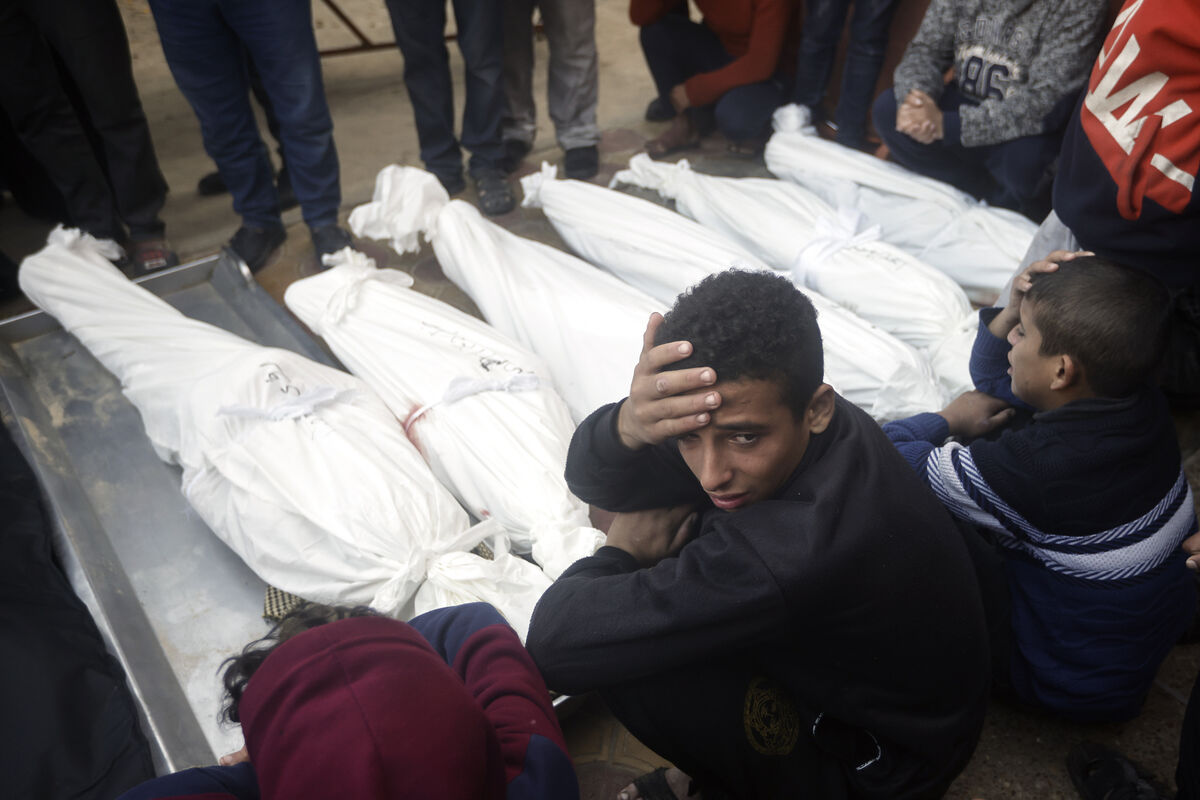 Palestinians mourn relatives killed in the Israeli bombardment of the Gaza Strip outside a morgue in Khan Younis on Thursday, Jan. 4, 2024.