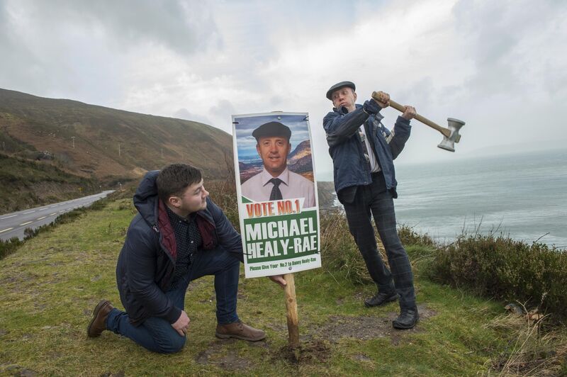 Michael Healy-Rae and son Jackie erect posters on the Wild Atlantic Way. Picture: Don MacMonagle
