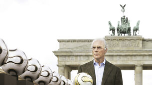 <p> German soccer legend Franz Beckenbauer, head of Germany's organising committee for the soccer World Cup, plays with the Golden Ball for the World Cup in front of the Brandenburg Gate in Berlin, on April 18, 2006. Germany's World Cup-winning coach Franz Beckenbauer has died. He was 78. Beckenbauer was one of German soccer's central figures. He captained West Germany to the World Cup title in 1974. He also coached the national side for its 1990 World Cup win against Argentina. (AP Photo/Jan Bauer, File)</p>