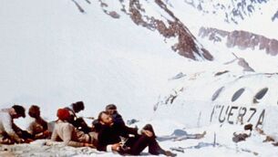<p>Nando Parrado interview: Survivors of the crash sitting beside the plane fuselage.</p>