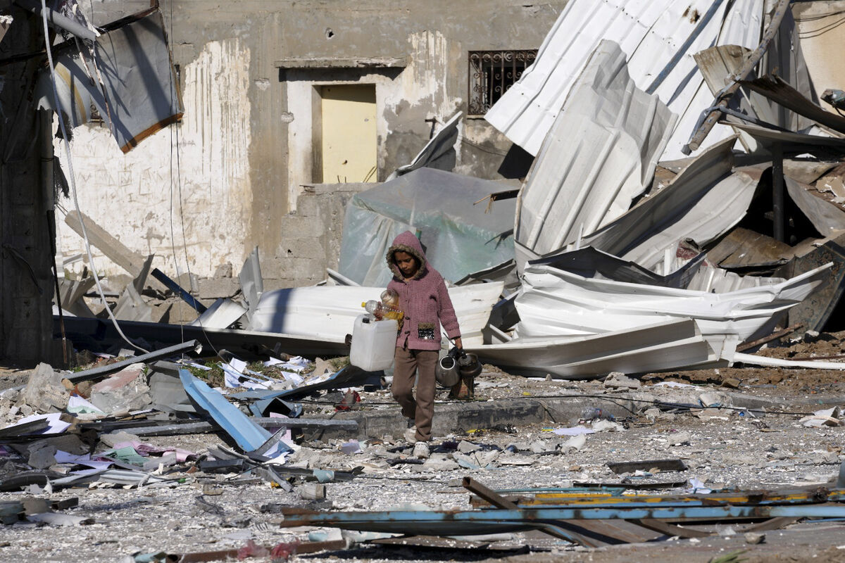 A Palestinian child walks past factories destroyed in the Israeli bombardment of the Gaza Strip in Deir al Balah. Picture: AP Photo/Adel Hana