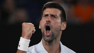 <p>Novak Djokovic celebrates winning the third set against Dino Prizmic (Andy Wong/AP)</p>