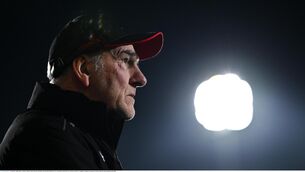 <p>Derry manager Mickey Harte looks on under the floodlights.</p>