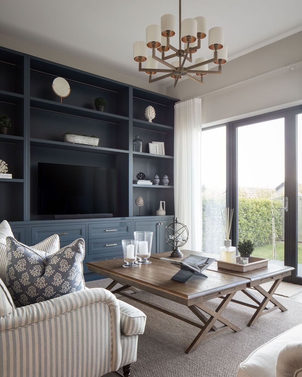  A modern living room light fitting is an update on traditional multi-bulb chandeliers as part of a lighting plan by Sarah Louise Interiors.