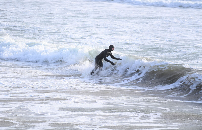  Surfer Cian O'Flynn from Castlelyons catches a wave in the water at Garretstown, Co Cork as the wind and waves begin to rise ahead of the oncoming Storm Isha. Picture: Larry Cummin