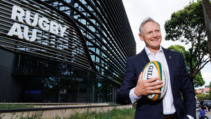 <p>MAN AT WORK: Joe Schmidt poses for photographs outside the Rugby Australia headquarters following a press conference about his appointment. Picture: INPHO/Photosport/Max Mason-Hubers</p>
