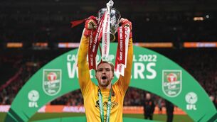 <p>CUP KEEPER: Caoimhin Kelleher of Liverpool lifts The Carabao Cup. Photo by Shaun Botterill/Getty Images.</p>