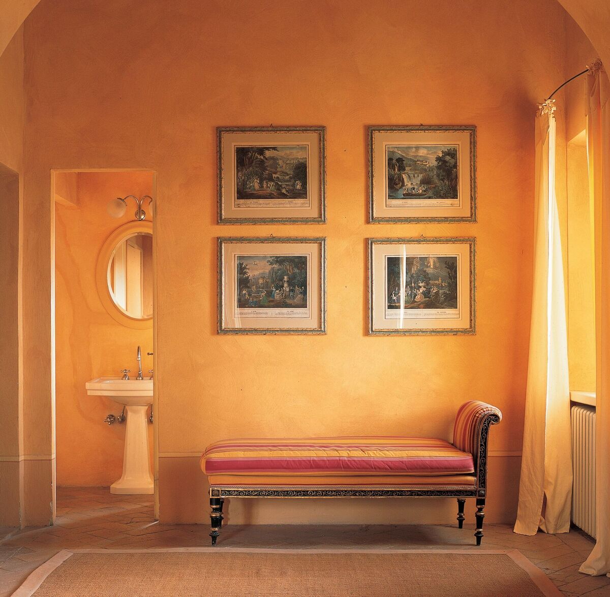  An 18th-century Italian farm building constructed to shelter livestock has been transformed into a comfortable home inspired by the textures and atmosphere of the surrounding countryside.