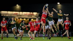 <p>HIGH STANDARD: Derry skipper Shane McGuigan wins the kick out in front of Kerry's Jason Foley and Diarmuid O'Connor at Austin Stack Park.</p>