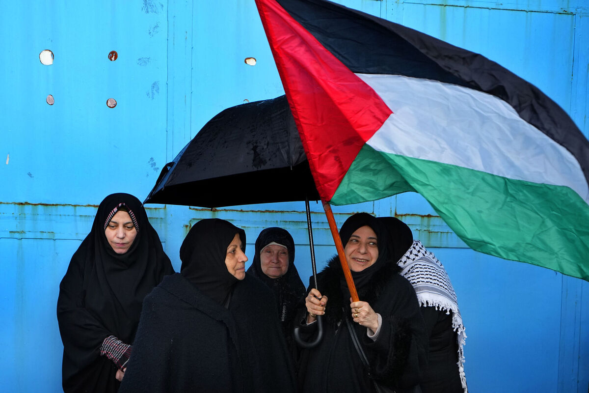 Palestinian Hamas supporters hold a Palestinians flag during a protest demanding that staff who were fired in the Gaza Strip over allegations that they took part in the Oct. 7, attack on southern Israel be returned to their jobs and that countries resume funding of the agency, in front of in front of the United Nations Relief and Works Agency (UNRWA) headquarters in Beirut, Lebanon, Tuesday, Jan. 30, 2024. (AP Photo/Bilal Hussein) Palestinian Hamas supporters hold a Palestinians flag during a protest demanding that staff who were fired in the Gaza Strip over allegations that they took part in the Oct. 7, attack on southern Israel be returned to their jobs and that countries resume funding of the agency, in front of in front of the United Nations Relief and Works Agency (UNRWA) headquarters in Beirut, Lebanon, Tuesday, Jan. 30, 2024. (AP Photo/Bilal Hussein)