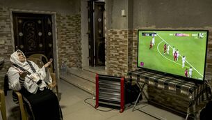 <p>The grandmother of Palestine's defender and captain Musab al-Battat prays as she watches the live television broadcast of the Qatar 2023 AFC Asian Cup football match between Qatar and Palestine. Picture:  HAZEM BADER/AFP via Getty Images</p>