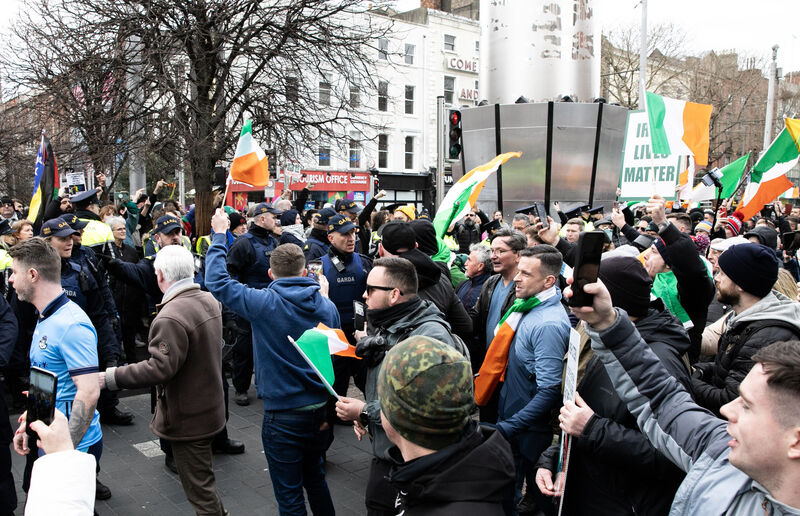 Anti-immigration demonstrators march past a counter-protest on O'Connell St in Dublin city centre on Monday. Picture: Gareth Chaney/Collins