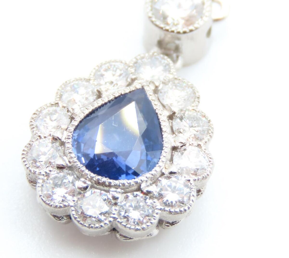 A pear-cut sapphire and diamond set pendant at Matthews.