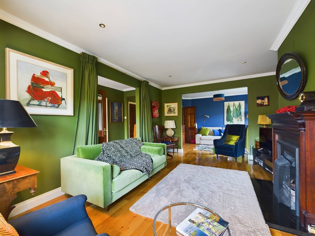 Curtains as a room divider to the hall give a sense of quiet drama