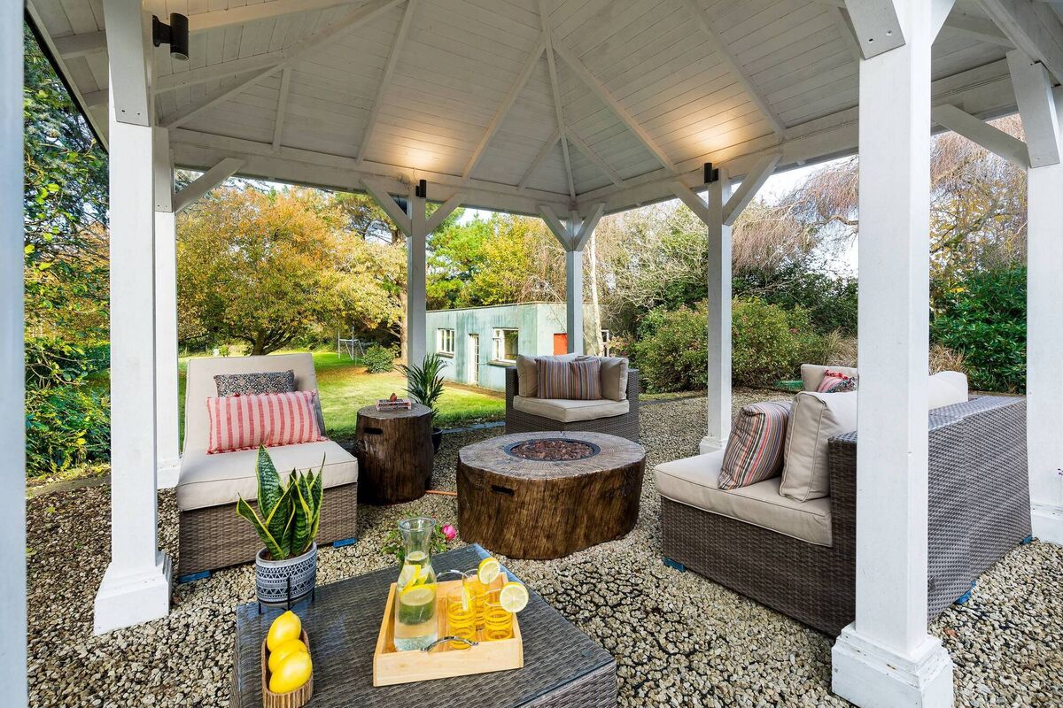 Gazebo with traditional cowshed in the background