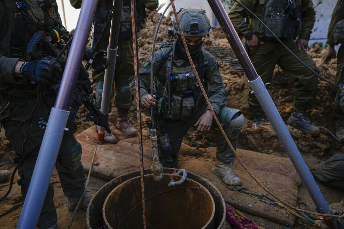 An Israeli soldier slides a camera down a hole inside the UNRWA compound courtyard where the military discovered tunnels underneath the main headquarters of the U.N. agency that the military says Hamas militants used to attack its forces during a ground operation in Gaza, Thursday, Feb. 8, 2024. Picture: AP Photo/Ariel Schalit
