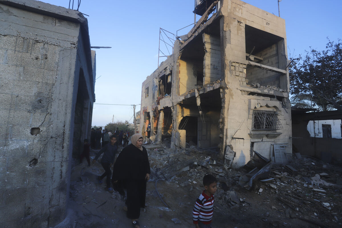 Palestinians walk by a residential building destroyed in an Israeli strike in Rafah. Picture: AP Photo/Hatem Ali Palestinians walk by a residential building destroyed in an Israeli strike in Rafah. Picture: AP Photo/Hatem Ali