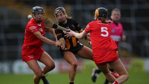 <p>Cork’s Laura Hayes and Aoife Healy tackles Katie Power of Kilkenny </p>