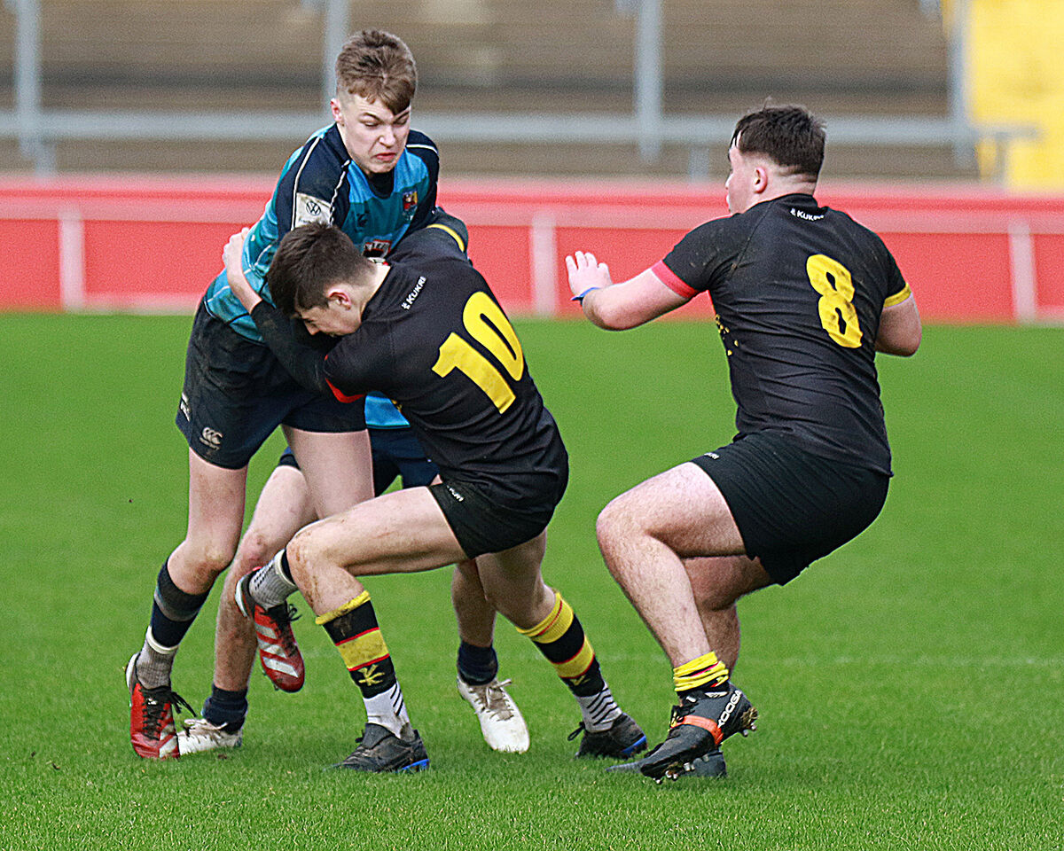 Cormac Devitt, Castletroy College under pressure from Jack Thorne and Leo Carmen, Ardscoil Ris in the Munster Schools Junior Cup Quarter Finals Cormac Devitt, Castletroy College under pressure from Jack Thorne and Leo Carmen, Ardscoil Ris in the Munster Schools Junior Cup Quarter Finals