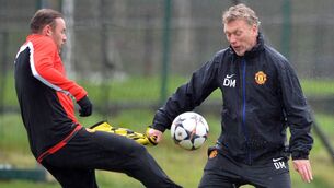 <p>Manchester United's Scottish manager David Moyes (R) takes part in a training session with Manchester United's English striker Wayne Rooney (L) at their Carrington training complex in Manchester, northwest England, on March 18, 2014</p>