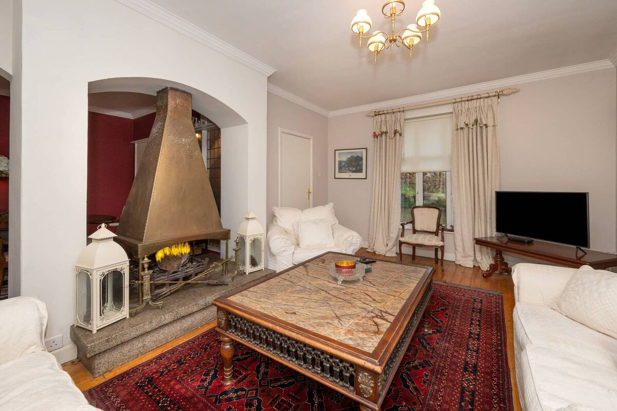 Fireplace with copper canopy opens to two rooms