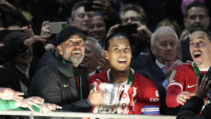 <p>ONTO THE NEXT...: Liverpool's manager Jurgen Klopp, left, lifts the trophy next to Liverpool's Virgil van Dijk. Pic: Dave Shopland, AP</p>